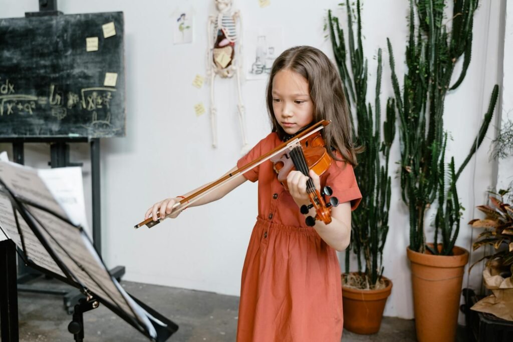 Child practicing violin indoors surrounded by educational and musical elements.